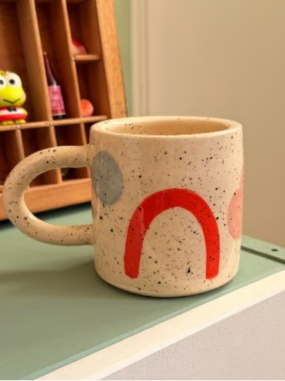 Speckled Ceramic Mug with Red Arch Accent